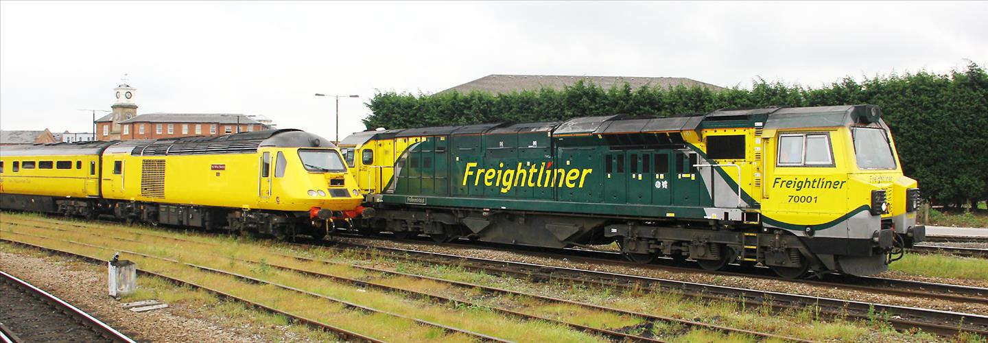 Posed alongside a passing Freightliner headed by 70001, 43014 The Railway Observer is about to lead the NMT away from Derby RTC, after the ceremony, on its first revenue run to Euston Photo: Mike Robinson